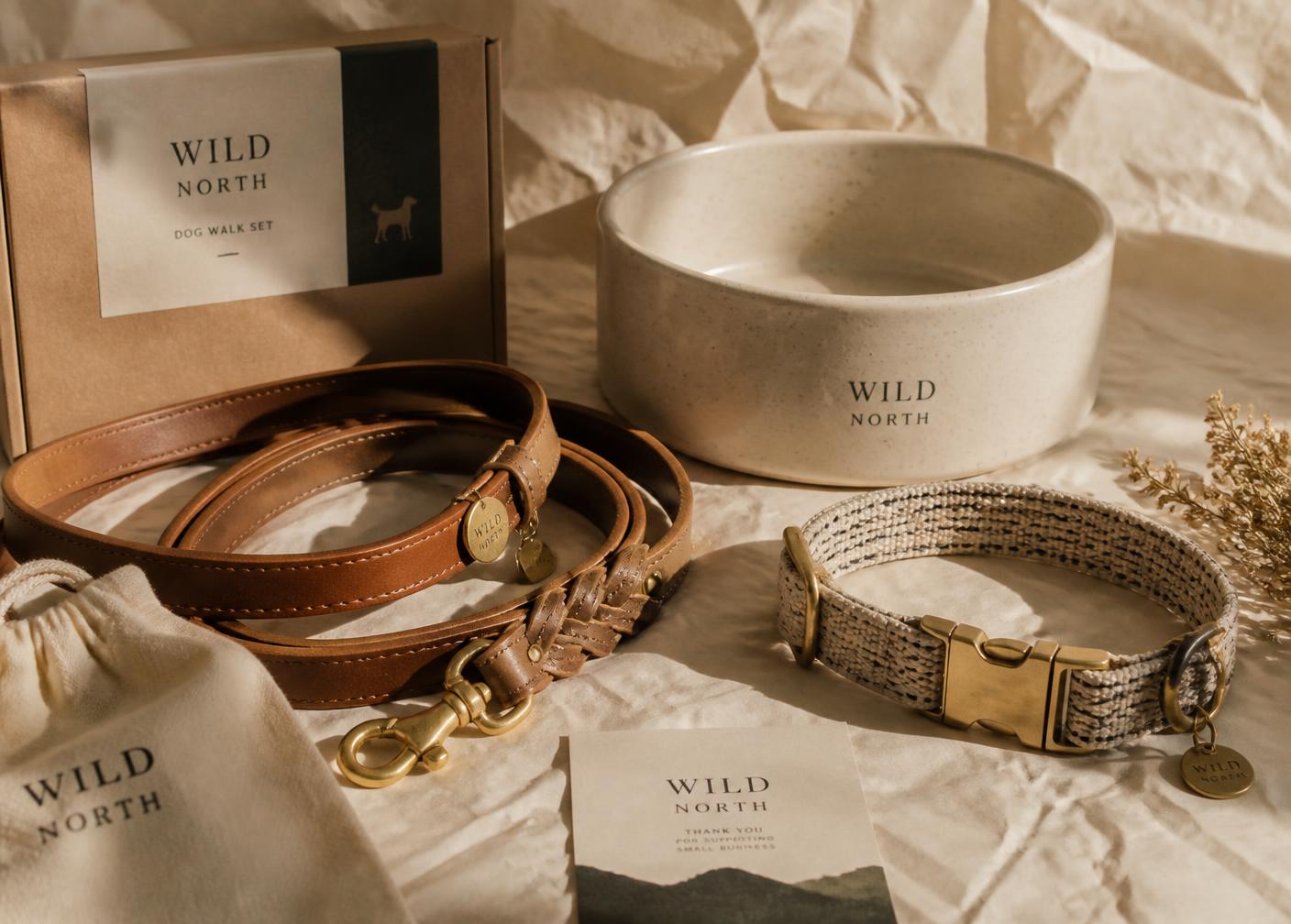 Leather leash, woven collar and ceramic bowl on cream paper
